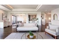 Bright living room featuring a stylish sofa, hardwood floors, and open layout with a kitchen view at 3475 Oak Valley Ne Rd # 2940, Atlanta, GA 30326
