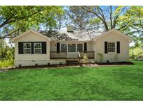 Charming, freshly renovated home with a green lawn and dark shutters at 1825 Sw Willis Mill Rd, Atlanta, GA 30311