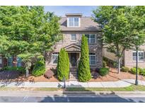 Charming brick home with well-maintained landscaping and mature trees in a desirable neighborhood at 486 Raven Brook Ln, Suwanee, GA 30024