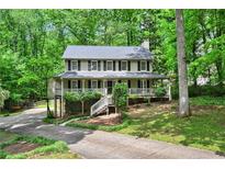 Charming two-story home features a welcoming front porch and a serene, wooded setting at 2253 Creekstone Ct, Marietta, GA 30062