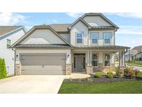 Charming two-story home with stone accents, manicured lawn, and a two-car garage offers excellent curb appeal at 351 Boundless Ln, Canton, GA 30114