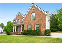 Charming brick two-story home with red shutters and well-manicured landscaping at 650 Virginia Highlands, Fayetteville, GA 30215