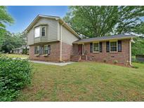 Charming brick home with a well-manicured lawn and lovely curb appeal at 387 Cascade Sw Dr, Lilburn, GA 30047