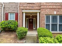 Charming brick home entrance with a welcoming front door, white columns, and well-manicured landscaping at 168 Constitution Blvd # 12, Lawrenceville, GA 30046
