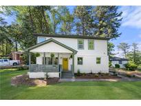 Charming two-story home with a welcoming front porch and a freshly landscaped front yard at 2111 Holly Hill Dr, Decatur, GA 30032