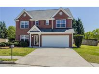Charming two-story brick home features a well-manicured lawn and attached two-car garage at 2775 Storybook Ct, Grayson, GA 30017