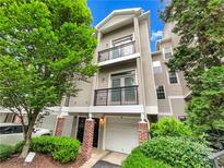 Charming townhome with a two-car garage and a lovely front exterior with brick columns and private balconies at 4254 River Green Nw Dr # 612, Atlanta, GA 30327