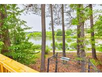 Relaxing backyard space featuring a serene lake view, and space to entertain around the wrought iron table set at 7737 Bar Harbor Dr, Riverdale, GA 30296