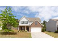 Inviting two-story home with a brick-accented facade, well-maintained lawn, and attached two-car garage at 2352 Allman Dr, Jonesboro, GA 30236