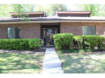 Charming brick home featuring manicured shrubbery and a well-maintained front yard, creating excellent curb appeal at 1457 Stoneleigh Cir, Stone Mountain, GA 30088
