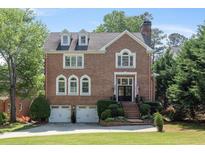Elegant two-story brick home featuring a well-manicured lawn, classic architectural details, and a welcoming entrance at 3003 W Roxboro Rd, Atlanta, GA 30324
