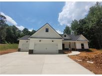 New construction home featuring a two-car garage and white siding, set against a lush green landscape at 877 Highway 101 N, Dallas, GA 30157