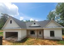Charming new construction home featuring a two-car garage and bright, white exterior siding at 877 Highway 101 N, Dallas, GA 30157