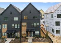 Beautiful new construction townhome with painted brick and modern black window and door trim at 656 Soul Aly # 101, Alpharetta, GA 30009