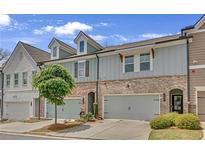 Charming townhome with brick and siding exterior, featuring a two-car garage and well-maintained landscaping at 360 Niles Ct, Marietta, GA 30060