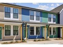 Charming street view of colorful, modern townhomes with individual entrances and well-kept landscaping at 1095 Tucker Ave # 503, Atlanta, GA 30310