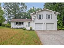 Charming two-story home with a two-car garage and nicely manicured front yard at 3182 Wakefield Dr, Decatur, GA 30034