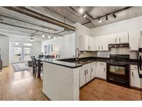 Well lit kitchen with white cabinetry, granite countertops, stainless steel appliances, and an open design at 800 Peachtree Ne St # 2304, Atlanta, GA 30308