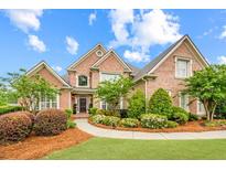 Stunning two-story brick home with manicured landscaping and inviting curb appeal at 1364 Gulfport Run, Grayson, GA 30017