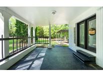 Inviting front porch with black railings, welcome sign, and views of the landscaped yard at 1369 N Highway 16, Whitesburg, GA 30185