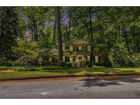 Charming two-story brick home with manicured lawn and mature trees offers a serene setting at 4111 Mcclatchey Ne Cir, Atlanta, GA 30342