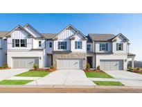 Charming townhomes with stone accents, garages, and manicured lawns create an inviting curb appeal at 4946 Jatoba Rd, Acworth, GA 30101