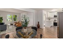 Open concept dining room featuring glass table and modern decor with lots of natural light at 3181 Pennington Sw Cir, Atlanta, GA 30354