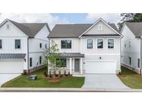 Charming two-story home with a well-manicured lawn, attached garage, and modern design at 1510 Gatekeeper Ter, Marietta, GA 30066