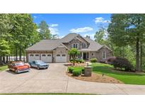 Charming two-story home features a three-car garage, stone accents and beautifully landscaped front yard at 922 Florence Rd, Douglasville, GA 30134