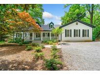 Charming home featuring white siding, black shutters, and a welcoming front porch at 1492 Frazier Rd, Decatur, GA 30033