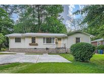 Charming single-story home with stone foundation and meticulously manicured lawn at 2685 Harrington Dr, Decatur, GA 30033