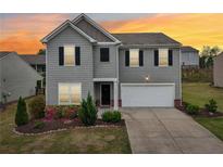 Charming two-story home featuring a well-manicured front yard and an attached two-car garage at 4615 Elmwood Trl, Cumming, GA 30028