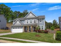 Charming two-story home with a well-manicured lawn, gray siding, and stone accents on the front porch columns at 162 Greenbrier Way, Canton, GA 30114