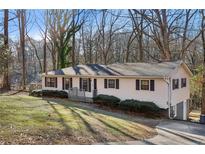 Charming single-story home with vinyl siding, black shutters, and a well-maintained front yard at 409 Katherine Ln, Woodstock, GA 30189