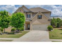 Charming two-story home with a well-manicured lawn and a two-car garage at 3049 Ivy Crossing Dr, Buford, GA 30519