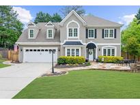 Charming two-story home with well-manicured lawn, attached two car garage and lush landscaping at 230 Bristolstone Ct, Alpharetta, GA 30005
