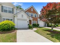 Charming townhome featuring a red brick accent, a single-car garage, and well-maintained landscaping at 3303 Timbercreek Cir, Roswell, GA 30076