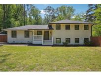 Charming renovated single-Gathering home featuring a freshly painted exterior and lush front lawn at 2710 Hayden Dr, East Point, GA 30344