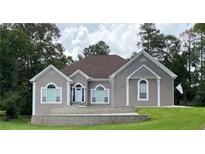 Charming single-story home with a well-maintained lawn and classic architectural details at 2507 Fairweather Se Ct, Conyers, GA 30013