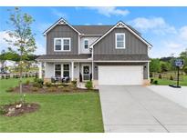 Charming two-story home with a well-manicured lawn, a basketball hoop, and a two-car garage at 837 Porches Way, Dacula, GA 30019