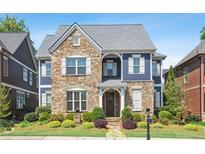 Charming two-story home featuring stone accents, blue siding, well-manicured landscaping and a welcoming entryway at 425 Hunt Ne St, Marietta, GA 30060
