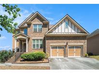 Beautiful two-story brick home with a two-car garage and well-manicured landscaping at 1057 Cotton Oak Dr, Lawrenceville, GA 30045