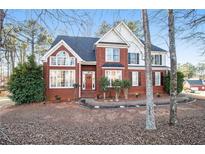 Charming brick home with well-manicured landscaping and a welcoming front entrance at 2118 Sableshire Se Way, Conyers, GA 30013