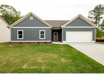 Charming single-Gathering home featuring a well-manicured lawn and a two-car garage at 1810 Forkview Ct, Lawrenceville, GA 30044