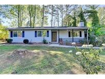 Charming one-story home with a well-maintained lawn and mature trees at 1824 Guardian Way, Lawrenceville, GA 30043