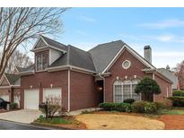 Charming two-story brick home with a two-car garage and well-maintained landscaping at 6275 Glen Oaks Ln, Atlanta, GA 30328