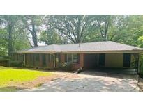Cozy one-story brick home with a large front yard and driveway at 6470 Sherwood Trl, Austell, GA 30168