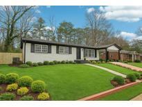 Charming one-story home with a beautifully manicured lawn and mature landscaping at 2401 Winshire Drive, Decatur, GA 30035