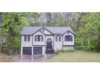 Charming two-story home featuring a well-maintained yard and a convenient two-car garage at 405 Settlers Ridge Ln, Hiram, GA 30141