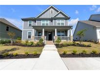 Beautiful two-story home features a welcoming front porch and well-maintained landscaping at 9913 Stretford Rd, Douglasville, GA 30135